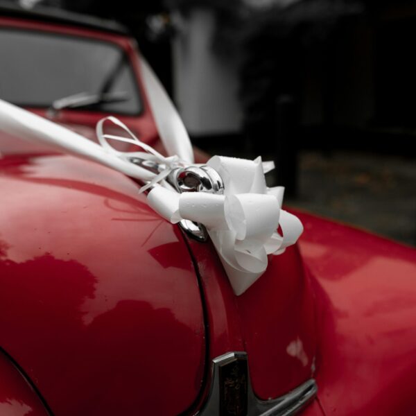 red rolls royce packed in ribbon cover image of an anonymous letter of safar-e-adab